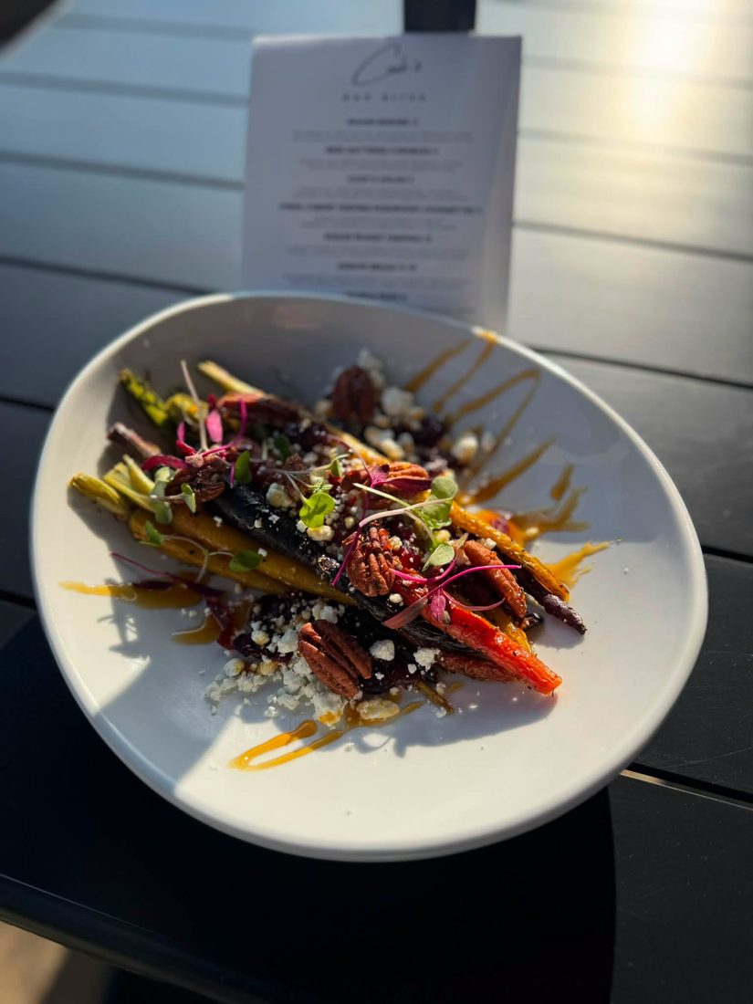 Roasted rainbow carrots with goat cheese, candied pecans, and microgreens